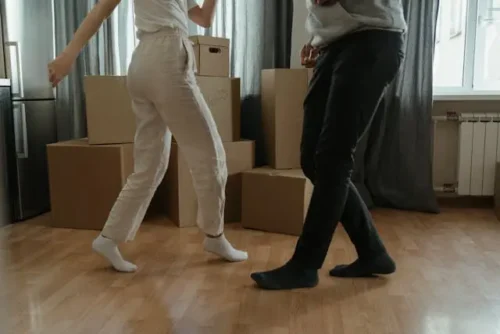 A couple dancing in their new home balancing work and life