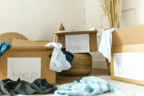 Boxes with clothes on the floor.