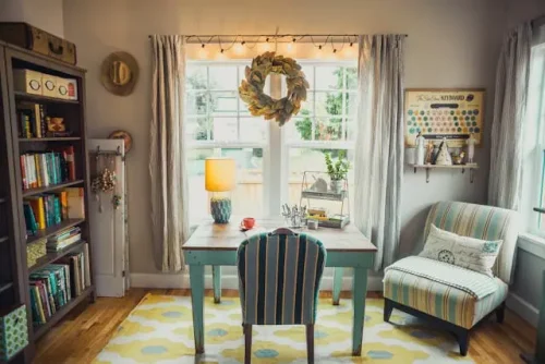 A small room with a sofa, bookshelf, and a table