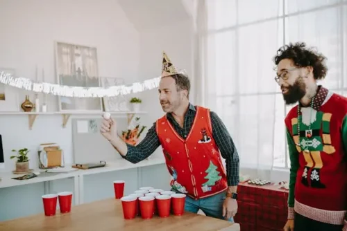 People playing beer pong in Housewarming Party.