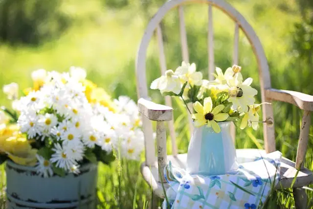 flowers in a vase on a chair.