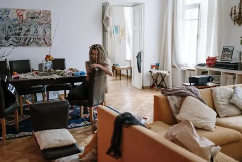 Women sitting in a messy apartment