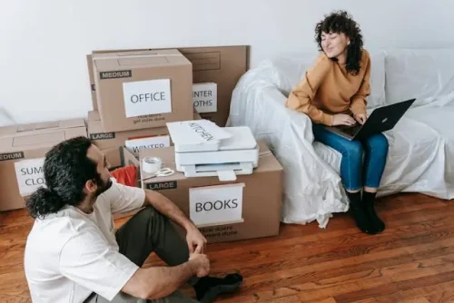 people sitting beside boxes