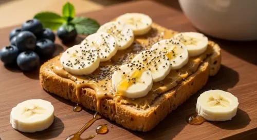 Whole grain toast topped with peanut butter and banana slices as a healthy vegan snack